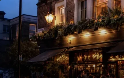 A warm pub exterior at dusk